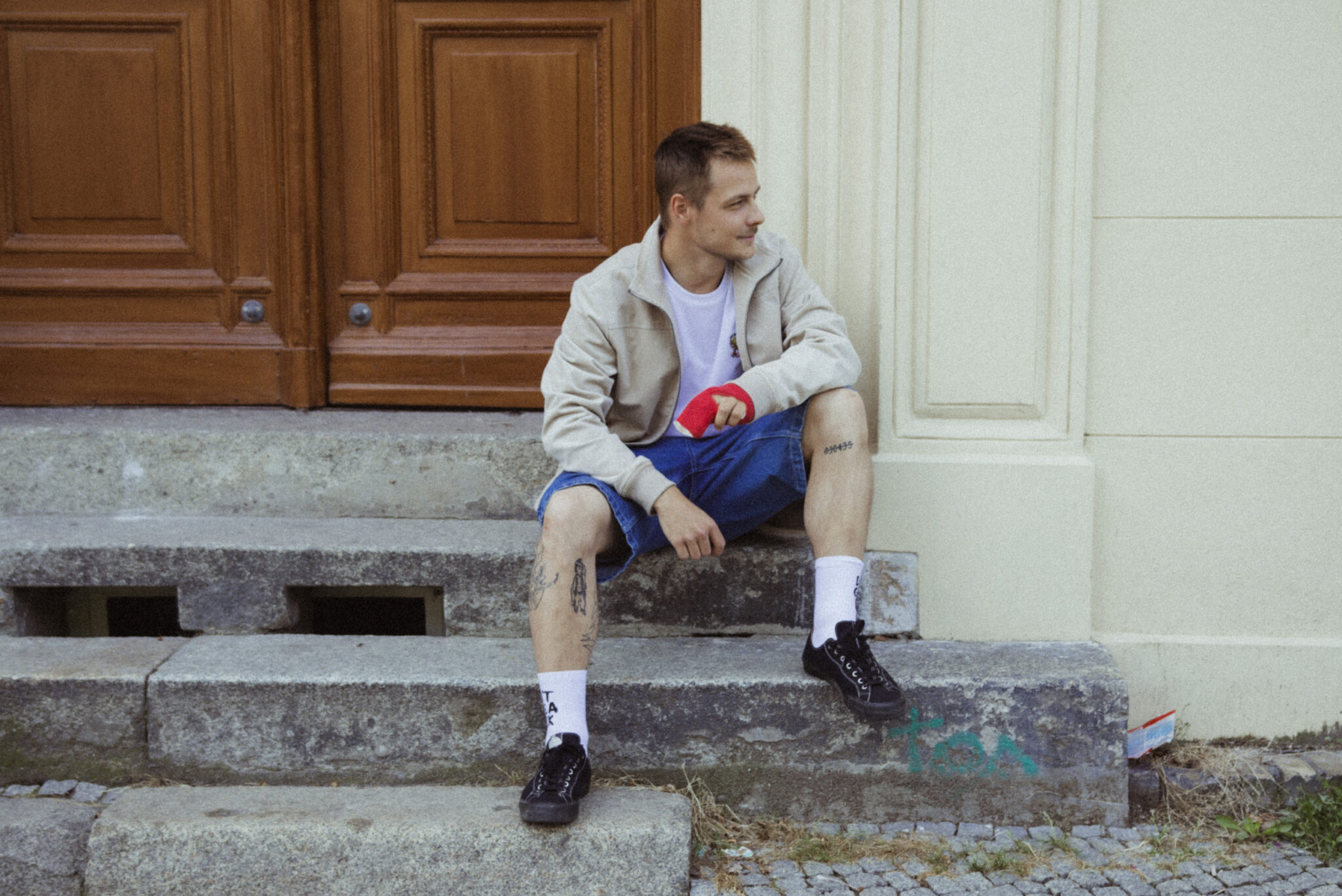 Person with creative hoodie in front of cardboard boxes