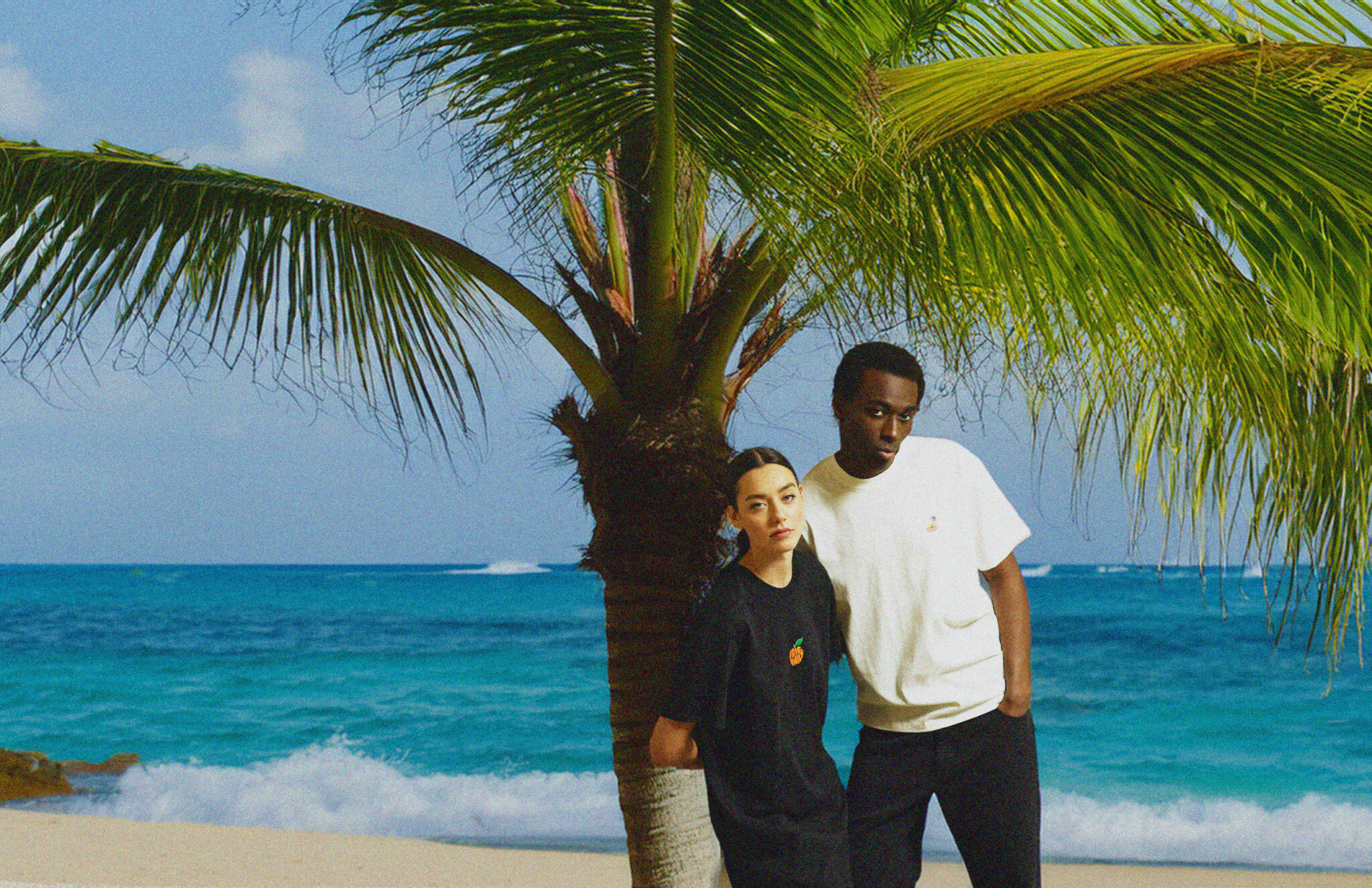 Two people in casual clothing, relaxed posture